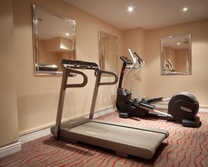 a gym with two tread machines in a room at Gresham Belson Hotel Brussels in Brussels