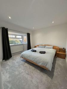a bedroom with a large bed and a window at A home away from home in Ash