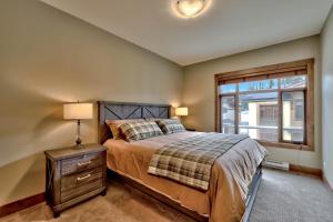 a bedroom with a bed and a window at 17 Village Walk Sun Peaks BC in Sun Peaks