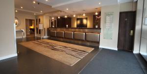 a dressing room with a large rug on the floor at Gresham Belson Hotel Brussels in Brussels