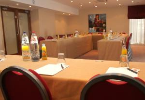 a row of tables with bottles of drinks on them at Gresham Belson Hotel Brussels in Brussels