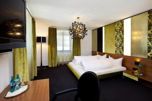 a hotel room with a bed and a desk at Schloss zu Hopferau in Hopferau +41 photos