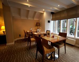 a dining room with wooden tables and chairs at Gresham Belson Hotel Brussels in Brussels