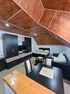 a room with a table and a room with a bed at VILA KRUNA Apartments in Kopaonik +36 photos