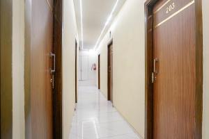 a corridor of a hospital with two doors at FabExpress Powai Inn in Mumbai