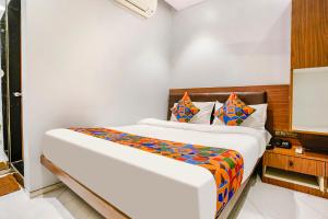 a bedroom with a large bed in a room at FabExpress Powai Inn in Mumbai