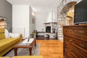 a living room with a yellow couch and a fireplace at House Bruna in Kršan
