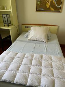 a bed with white sheets and pillows in a bedroom at Fenix Villa in Noicattaro
