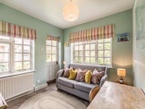 a living room with a couch and windows at Uk44005 - Carters Yard in Kimbolton