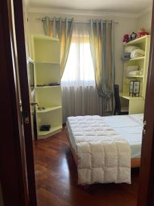 a bedroom with a bed and a window at Fenix Villa in Noicattaro