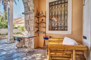a porch with a couch and a table on a patio at Apartments Old Sailor s House in Mali Lošinj