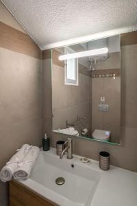 a bathroom with a sink and a mirror at stefanos house in Aliki
