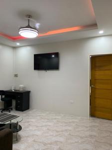 a room with a flat screen tv on a wall at Zagill Moalboal in Moalboal