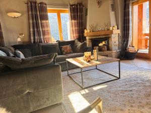 a living room with a couch and a coffee table at Le Preyet in Veysonnaz