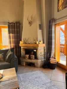 a living room with a fireplace and a couch at Le Preyet in Veysonnaz
