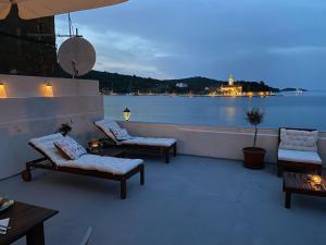 a patio with couches and a view of the water at Waterfront House Carolina in Vis