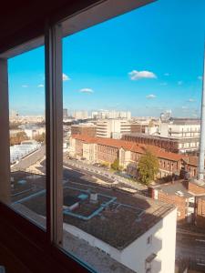 a view of a city from a window at Appartement Paris vue imprenable in Le Kremlin-Bicêtre +10 photos