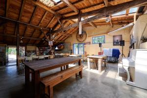a large room with a wooden table and chairs at Glamping Dordogne in Douville