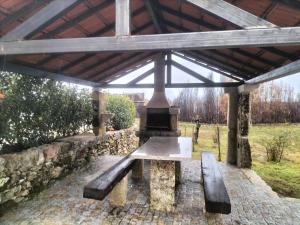a pavilion with a bench under a roof at Quinta Do Marmeiral in Mangualde +27 photos