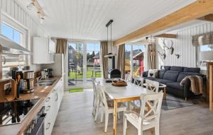 a kitchen and living room with a table and chairs at Holla Die Waldfee in Wandlitz