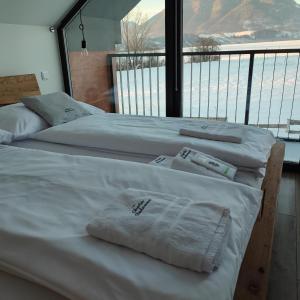 three beds in a room with a large window at Chata Balance in Žiar