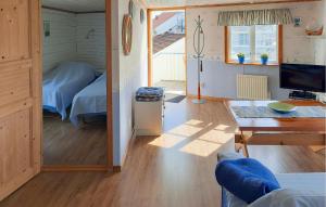 a room with a bed and a desk and a television at Beautiful Apartment In Skärhamn in Skärhamn