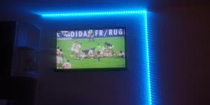 a television in a room with a blue light at Bel Appt Plein Coeur de Saint Lary Soulan in Saint-Lary-Soulan +7 photos