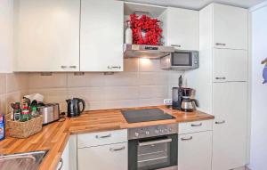 a kitchen with white cabinets and a counter top at Ferienhaus Ostseebad Breege in Breege