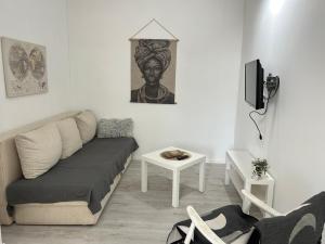 a living room with a couch and a tv at Apartments Mitende in Budva