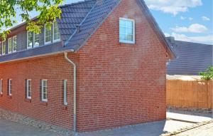 a red brick building with a black roof at Ferienwohnung Feldberger in Conow +2 photos