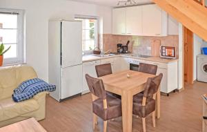a kitchen and dining room with a table and chairs at Ferienwohnung Feldberger in Conow