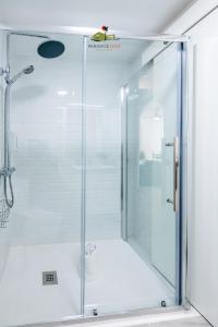 a shower with a glass door in a bathroom at Casa Alubsan in Puerto del Rosario +51 photos