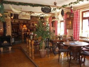 a restaurant with tables and chairs and a plant at Gasthaus Alte Brauerei in Ettenheim