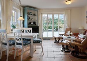 a living room with a table and chairs at Fewo Arnfried Whg 5 in Wenningstedt