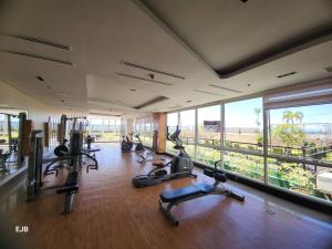 a gym with a bunch of treadmills and exercise bikes at C1-7G Executive Studio with pool , 8boulevard Mactan Newtown in Lapu Lapu City