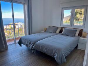 a bedroom with a large bed with a large window at Finca Ecologica Ten Days in La Orotava