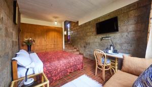 a room with a bed and a table and a couch at Villa Rock Stop Falls Gigiri in Nairobi