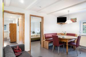 Una sala de estar y un comedor con mesa y sillas. en Zuckerbauernhof-Ferien in der Natur, en Sankt Georgen