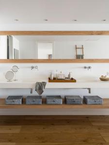 Un baño con una estantería con tres lavabos y espejos. en Colonia Beach House, en Colonia de Sant Jordi 28 fotos más