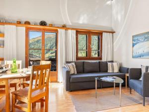 a living room with a couch and a table at Apartment Aragon F130 by Interhome in Ernen