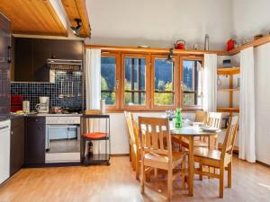 a kitchen and dining room with a table and chairs at Apartment Aragon F130 by Interhome in Ernen