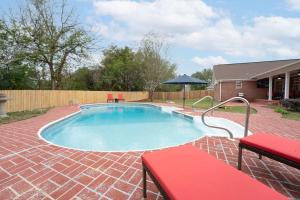 a swimming pool in a yard with a brick patio at 15 Min to UA Private Heated Pool Huge Yard Luxe Master in Tuscaloosa