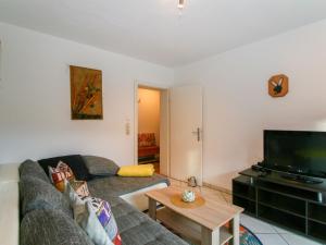 a living room with a couch and a tv at Apartment Bair - MHO535 by Interhome in Hippach +29 photos