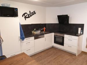 Kuchyň nebo kuchyňský kout v ubytování Apartment Gletscherhorn II - Tapia by Interhome