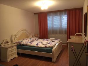 a bedroom with a bed and a dresser and a window at Apartment Blumenweg 8 by Interhome in Engelberg