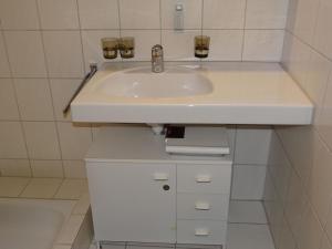 a bathroom with a white sink in a room at Apartment Blumenweg 8 by Interhome in Engelberg