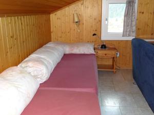 a large bed in a room with a table and a window at Apartment Berg Edelweiss by Interhome in Engelberg