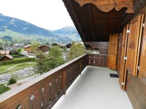 a balcony with a view of the mountains at Apartment Hornflue - Baumann by Interhome in Gstaad +28 photos