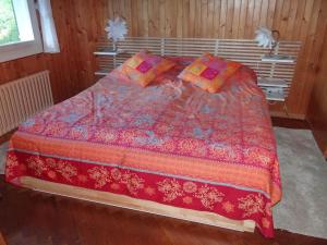 a bedroom with a large bed with a red comforter at Apartment Casa Mira by Interhome in Engelberg