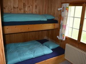 a room with two bunk beds and a window at Apartment Chalet Heureka-Horbis by Interhome in Engelberg +3 photos